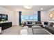 Spacious living room featuring modern decor, plush seating, and ample natural light for relaxed living at 15148 Willow Ridge Dr, Montverde, FL 34756