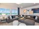 Comfortable living room featuring a large gray sectional, unique wall decor, and plenty of natural light at 15148 Willow Ridge Dr, Montverde, FL 34756