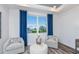 Cozy sitting area with comfortable chairs, a small table, and a bright window with neighborhood views at 15148 Willow Ridge Dr, Montverde, FL 34756