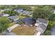 An elevated view shows a lovely home with a dark roof, green lawn, nearby houses, and a street at 18 Cooledge St, Winter Garden, FL 34787