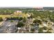 Aerial view showcases a baseball park and a neighborhood area with homes, streets, and businesses at 18 Cooledge St, Winter Garden, FL 34787