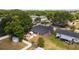 This aerial perspective highlights the property's backyard, patio, and fence, along with the surrounding neighborhood at 18 Cooledge St, Winter Garden, FL 34787