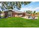 A well-maintained backyard includes a paver patio, gazebo, and open lawn space, ideal for relaxation and recreation at 18 Cooledge St, Winter Garden, FL 34787