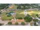 An aerial view of a well-maintained baseball field and green sports field with a charming neighborhood nearby at 18 Cooledge St, Winter Garden, FL 34787