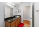 This bathroom features a long vanity, a large mirror and wood cabinets at 18 Cooledge St, Winter Garden, FL 34787