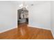 Inviting dining room with hardwood floors, neutral paint, and an archway leading to the kitchen at 18 Cooledge St, Winter Garden, FL 34787