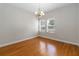 Formal dining room boasts natural light, gleaming hardwood floors, and modern chandelier at 18 Cooledge St, Winter Garden, FL 34787