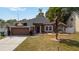 Charming single-story home with a well-manicured lawn, landscaping, and a convenient two-car garage at 18 Cooledge St, Winter Garden, FL 34787
