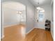 Bright foyer featuring wood floors, a decorative glass door, and arched doorways at 18 Cooledge St, Winter Garden, FL 34787