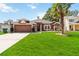 Beautiful one-story home with a lush green lawn, mature palm tree, and a two-car garage at 18 Cooledge St, Winter Garden, FL 34787