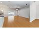 Spacious living room with wood floors, a ceiling fan, neutral walls, and sliding glass doors to a screened patio at 18 Cooledge St, Winter Garden, FL 34787