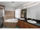 Main bathroom featuring double sinks, a soaking tub, and a separate shower stall at 18 Cooledge St, Winter Garden, FL 34787