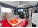 This main bedroom features a large window, a ceiling fan, and a TV at 18 Cooledge St, Winter Garden, FL 34787