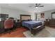 Comfortable main bedroom with a ceiling fan, tray ceiling, and ample space at 18 Cooledge St, Winter Garden, FL 34787