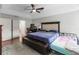 Spacious main bedroom featuring a ceiling fan, tray ceilings, and hardwood floors at 18 Cooledge St, Winter Garden, FL 34787
