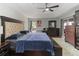 Bright main bedroom featuring a ceiling fan, hardwood floors, and ample closet space at 18 Cooledge St, Winter Garden, FL 34787