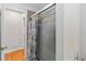 This bathroom features a shower with a sliding glass door and wood floor at 18 Cooledge St, Winter Garden, FL 34787