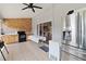 Spacious sunroom with tile flooring, refrigerator, and access to the backyard at 18 Cooledge St, Winter Garden, FL 34787
