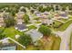 Overhead view of a home with large backyard, mature trees and community neighborhood at 201 Churchill Ct, Kissimmee, FL 34758