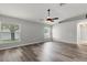 Inviting bedroom with sleek wood-look floors, two windows, and vaulted ceiling with fan at 201 Churchill Ct, Kissimmee, FL 34758