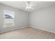 Bright bedroom features a ceiling fan and a window with blinds at 201 Churchill Ct, Kissimmee, FL 34758