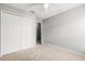 A bright bedroom features a closet with double doors and neutral carpet at 201 Churchill Ct, Kissimmee, FL 34758