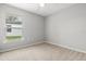 A bright bedroom with a window, ceiling fan and neutral carpet at 201 Churchill Ct, Kissimmee, FL 34758