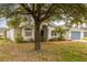 Lovely single-story home with arched entryway, mature landscaping, and a well-manicured lawn at 201 Churchill Ct, Kissimmee, FL 34758