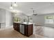 Open kitchen with center island, sink, and view to living area and backyard at 201 Churchill Ct, Kissimmee, FL 34758