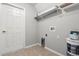 A laundry room featuring a door, shelf, paint cans and hookups at 201 Churchill Ct, Kissimmee, FL 34758