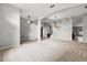 Large living room with carpeted and tiled areas, fan, and arched doorways, offering an open floor plan at 201 Churchill Ct, Kissimmee, FL 34758