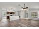 Open-concept living space with wood floors, pendant lighting, breakfast bar, and kitchen view at 201 Churchill Ct, Kissimmee, FL 34758