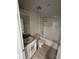 A bright bathroom featuring granite counters, a single sink, and a stylish tiled shower and tub at 2025 Claudia Ln # 2025, Kissimmee, FL 34741