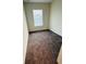 A small bedroom features neutral walls, cozy carpeting, and a bright window at 2025 Claudia Ln # 2025, Kissimmee, FL 34741