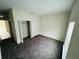 A bright bedroom features neutral walls, cozy carpeting, and a closet for storage at 2025 Claudia Ln # 2025, Kissimmee, FL 34741