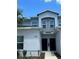 Two-story townhome featuring a modern facade, black front doors, and a well-maintained lawn at 2025 Claudia Ln # 2025, Kissimmee, FL 34741