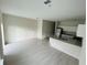 Bright living room with an open floor plan flowing into a kitchen with modern finishes at 2025 Claudia Ln # 2025, Kissimmee, FL 34741