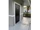 Community restroom with an accessible black door surrounded by grey stucco and a decorative exterior light at 2025 Claudia Ln # 2025, Kissimmee, FL 34741