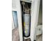 A well maintained hot water tank within a utility closet and next to a bathroom sink at 2025 Claudia Ln # 2025, Kissimmee, FL 34741