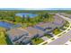 Aerial view of a row of single-Gathering homes near a retention pond at 2490 Southlawn Ln, Clermont, FL 34714
