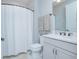 Clean bathroom features a shower and a vanity with modern fixtures and grey towels at 2490 Southlawn Ln, Clermont, FL 34714