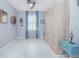 The bedroom is decorated with a ceiling fan and wooden decor, and is brightly lit by a window at 2490 Southlawn Ln, Clermont, FL 34714