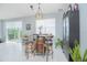 Cozy breakfast nook featuring a barrel table, bar stools, and natural lighting at 2490 Southlawn Ln, Clermont, FL 34714