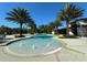 Zero entry community pool with fountains surrounded by lounge chairs and tropical landscaping at 2490 Southlawn Ln, Clermont, FL 34714
