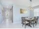 Dining area featuring a table with seating and view of the hallway at 2490 Southlawn Ln, Clermont, FL 34714