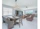 Open-concept dining area featuring a stylish table, seating, and natural lighting at 2490 Southlawn Ln, Clermont, FL 34714