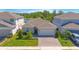 Charming single-Gathering home with brick driveway, well-manicured lawn, and two-car garage at 2490 Southlawn Ln, Clermont, FL 34714