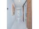 Inviting hallway with light gray paint, tile floors, and rustic barn door provides seamless style to the house at 2490 Southlawn Ln, Clermont, FL 34714