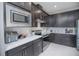 This kitchen features stainless steel appliances, stylish cabinets, and plenty of counter space for meal prep at 2490 Southlawn Ln, Clermont, FL 34714