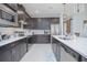 Modern kitchen with stainless steel appliances and an island with a sink at 2490 Southlawn Ln, Clermont, FL 34714